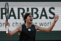 Germany's Alexander Zverev celebrates as he defeats Spain's Carlos Alcaraz during their quarterfinal match of the French Open tennis tournament at the Roland Garros stadium Tuesday, May 31, 2022 in Paris. Zverev won 6-4-, 6-4, 4-6, 7-6 (9/7). (AP Photo/Thibault Camus)