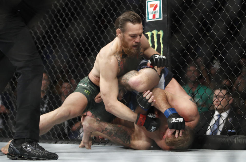 Conor McGregor hits Donald "Cowboy" Cerrone during a UFC 246 welterweight mixed martial arts bout Saturday, Jan. 18, 2020, in Las Vegas. (AP Photo/John Locher)