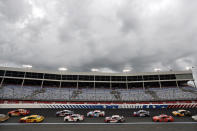 Dark clouds fill the sky during the NASCAR Cup Series auto race at Charlotte Motor Speedway Sunday, May 24, 2020, in Concord, N.C. (AP Photo/Gerry Broome)