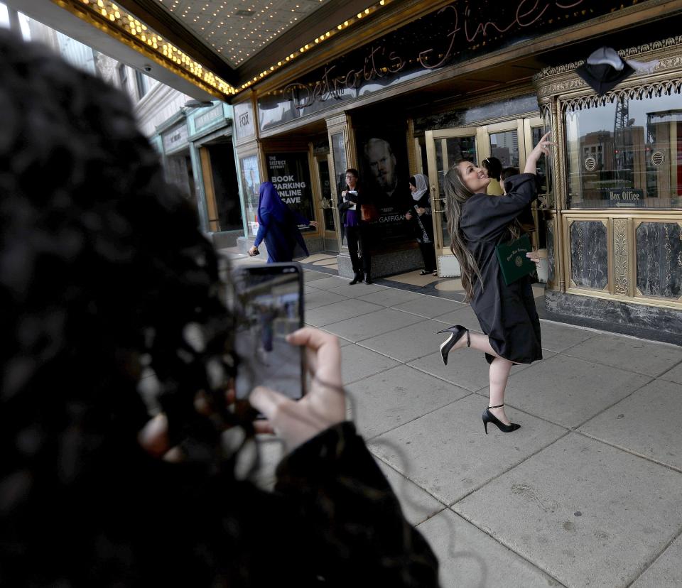 Intisar Fawaz, 22 has fun with her graduation cap as her sister Naveen Fawaz photographs her with her iPhone in front of the Fox Theatre in downtown Detroit on Friday, May 3, 2019.
Fawaz had just graduated from Wayne State University with a Bachelors of Arts in Biology.