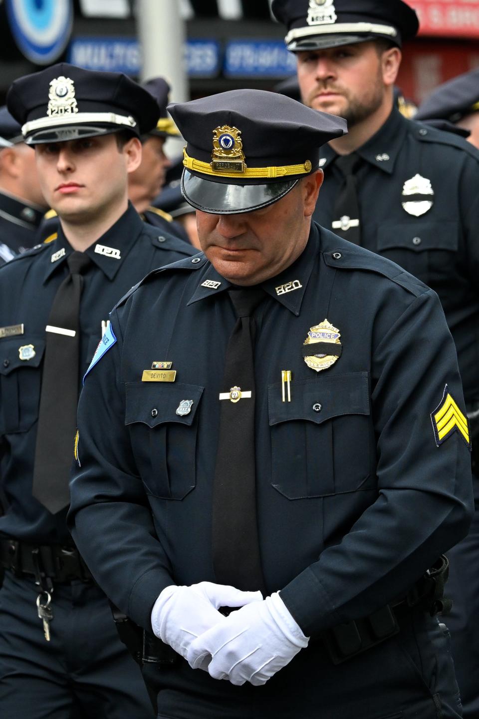 Billerica, Massachusetts, Police Sgt. Andrew Devito lowers his head during funeral services for fellow officer Sgt. Ian Taylor, who was killed on April 26 while working a detail.