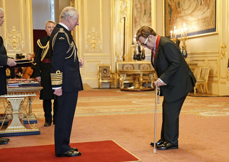 Sir Elton John is made a member of the Order of the Companions of Honour by Prince Charles during an investiture ceremony at Windsor Castle, in Windsor, England, Wednesday, Nov. 10, 2021. (Aaron Chown/PA via AP)