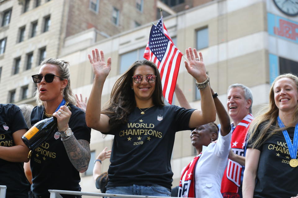 Carli Lloyd acknowledges the crowds as the U.S. women's soccer team is celebrated with a parade along the Canyon of Heroes, Wednesday, July 10, 2019, in New York. (Photo: Gordon Donovan/Yahoo News)