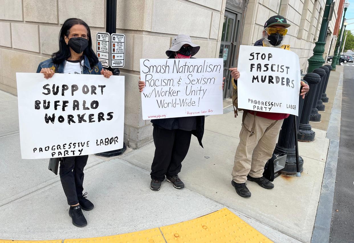 Ruth Rodriguez, left, Gwen Davis and Gordon T. Davis of the Progressive Labor Party hold a small demonstration Wednesday at Main and Austin streets to bring attention to the shooting in Buffalo, N.Y., Saturday. Gordon Davis said that they wanted to speak out about the violence and condemn the racist conspiracy theories that inspired the shooter.