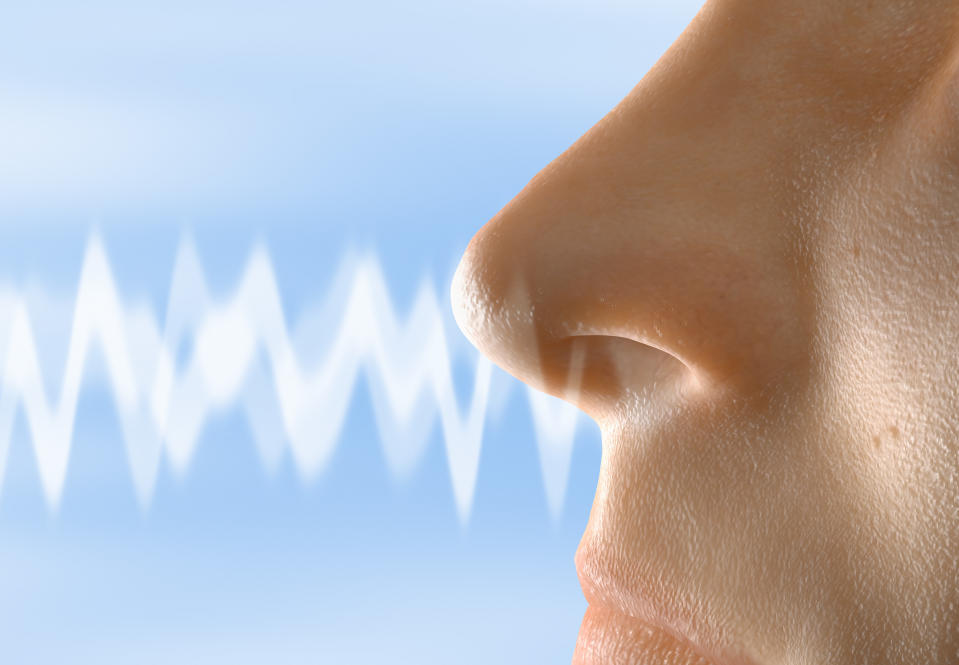 Close up visualization of a smell moving towards a human nose.