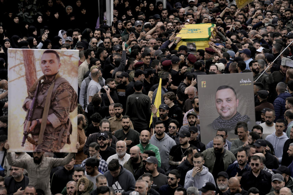 Hezbollah fighters carry the coffin of their comrade, Ali Ahmad Hussein, who was killed by an Israeli strike in south Lebanon, during his funeral procession in the southern Beirut suburb of Dahiyeh, Lebanon, Monday, April 8, 2024. Israel's military says it has killed a commander of Hezbollah's secretive Radwan Force in southern Lebanon. (AP Photo/Bilal Hussein)