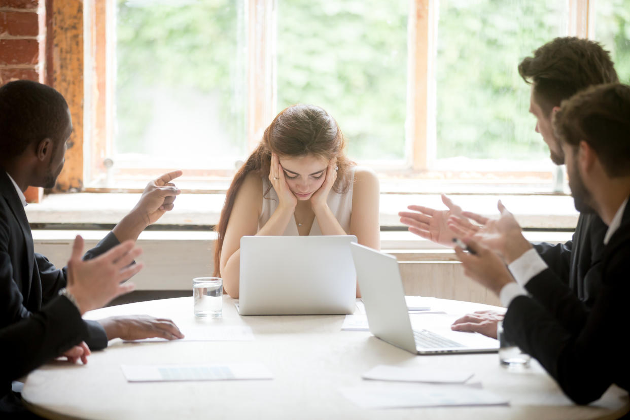 Woman having a hard time in a meeting full of women. (Getty Images)