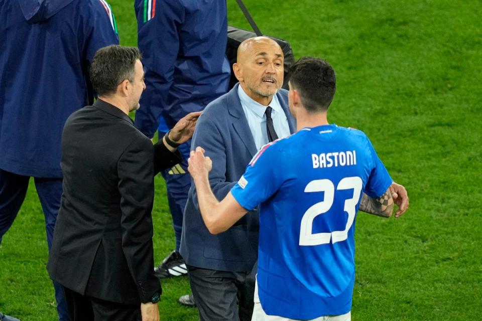 Italy's head coach Spalletti shakes hands with Bastoni (AP)