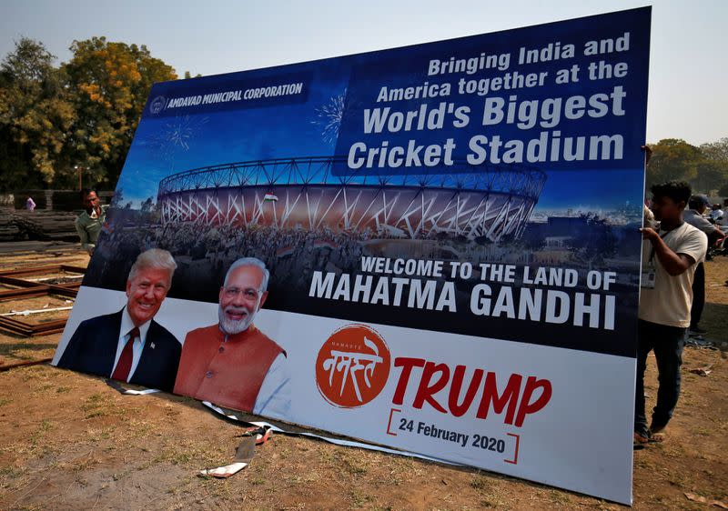 Workers prepare a hoarding with the images of the U.S. President Donald Trump and India's Prime Minister Narendra Modi ahead of Trump's visit, on the outskirts of Ahmedabad