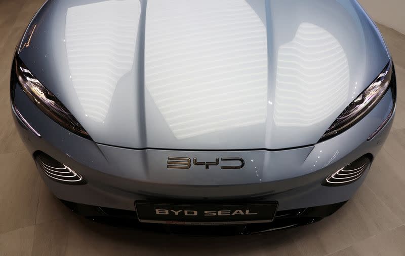 A BYD Seal electric vehicle is displayed at a BYD By 1826 cafe and car dealership in Singapore