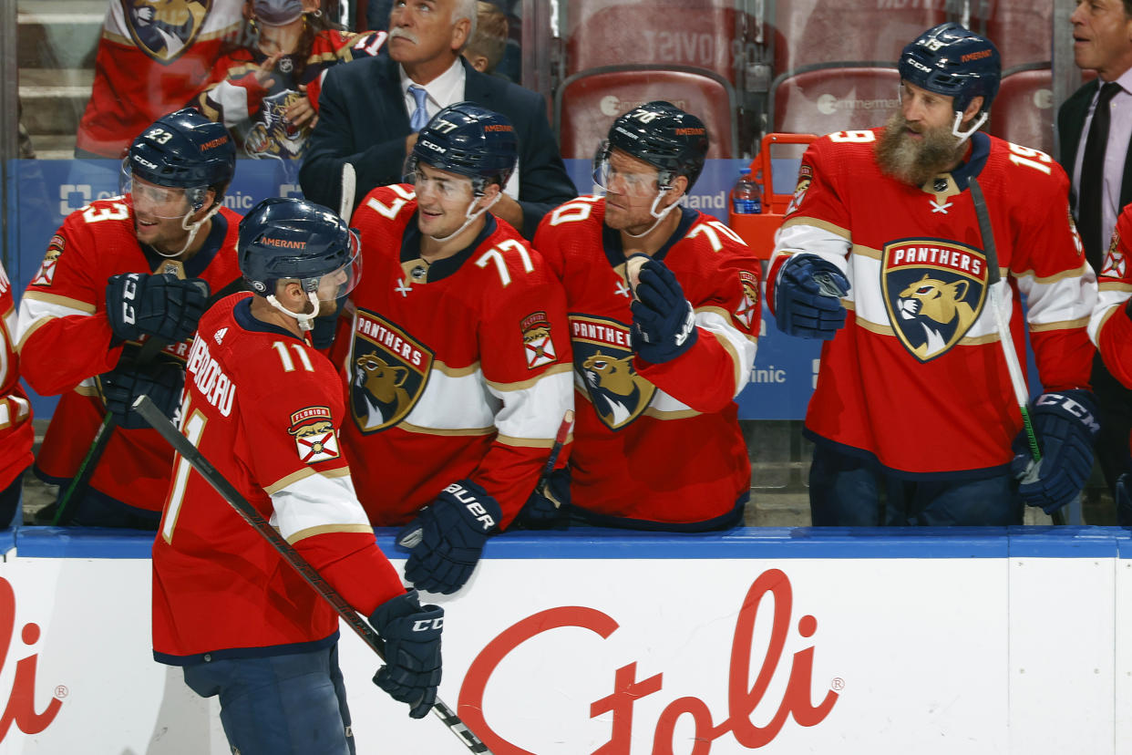 SUNRISE, FL - OCTOBER 25: Teammates congratulate Jonathan Huberdeau #11 of the Florida Panthers after he scored a third period goal against the Arizona Coyotes at the FLA Live Arena on October 25, 2021 in Sunrise, Florida. (Photo by Joel Auerbach/Getty Images)