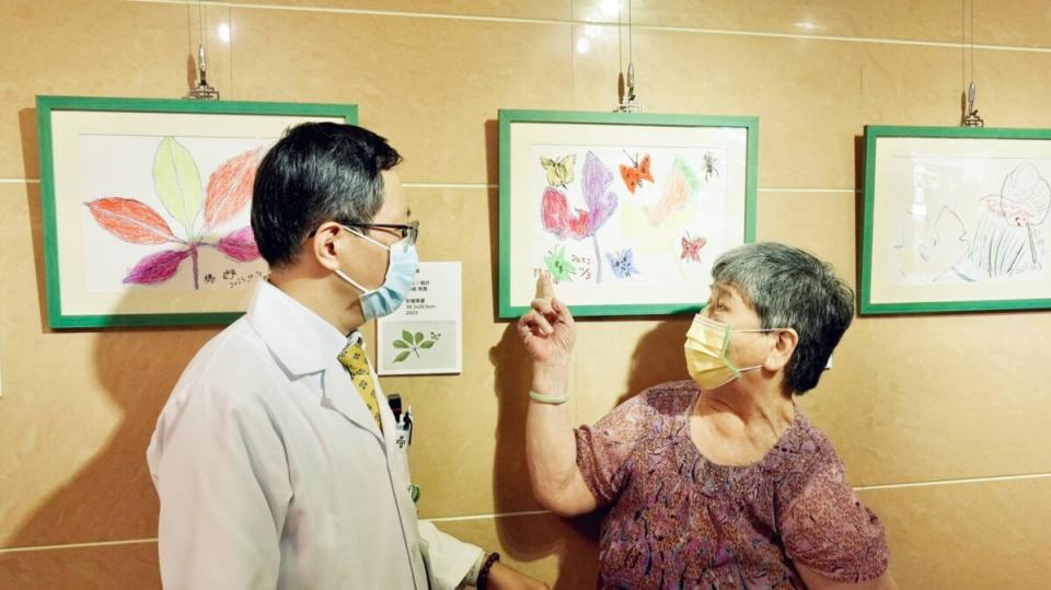 ▲91歲的陳阿嬤跟彰濱秀傳神經內科主任魏誠佑介紹她的畫作「蝶與樹」。（記者林明佑翻攝）