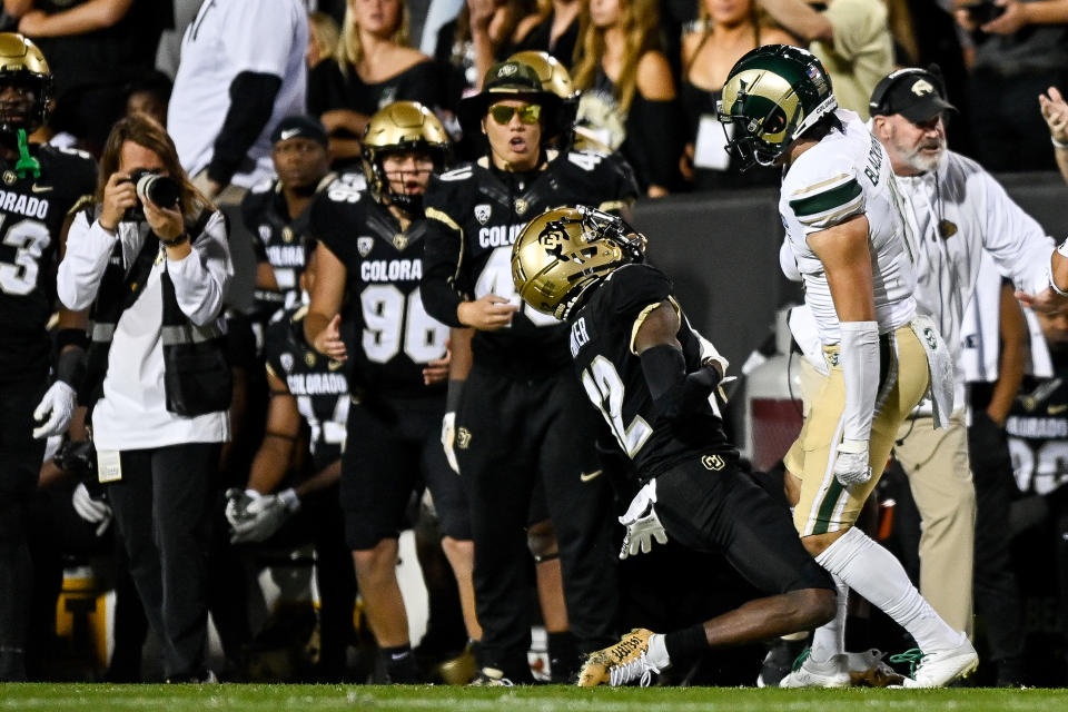 Colorado Buffaloes WR Travis Hunter is hit near the sideline by Colorado State's Henry Blackburn on Sept. 16. (Dustin Bradford/Getty Images)