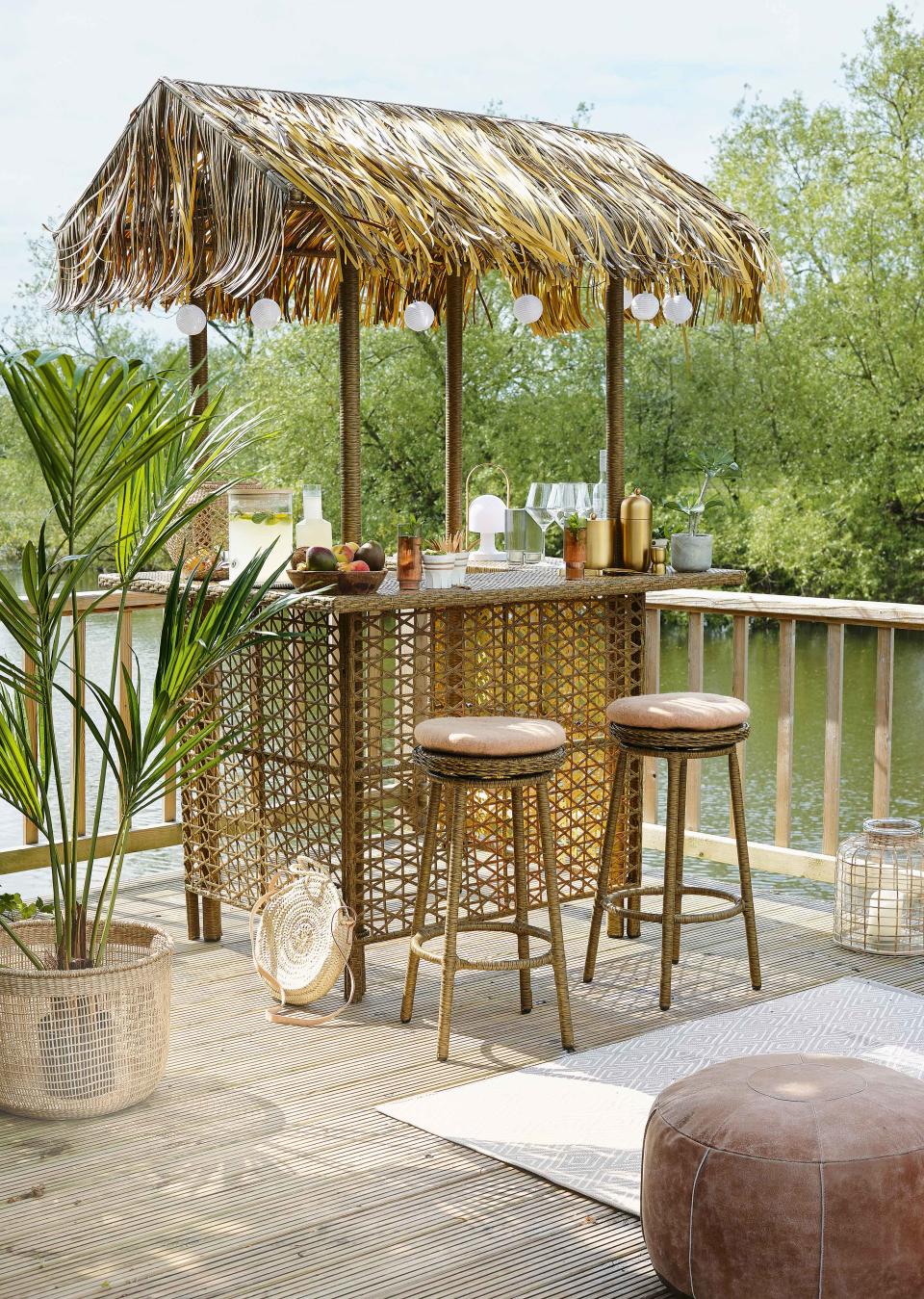 <p> Speaking of vacation vibes, why not go all out, save on the air miles and transform your garden into a paradise with a tropical outdoor bar? A rattan-style setup with thatch-inspired roof is just what you need for a laid-back, beachy vibe. </p> <p> Pop a palm or two nearby and add a string of festoon lights for a welcoming glow after dark. And for a grown-up take on the theme, keep colors neutral and materials natural. </p> <p> All that's left to do is rustle up a piña colada – you'll be in holiday-mode before you know it. </p>