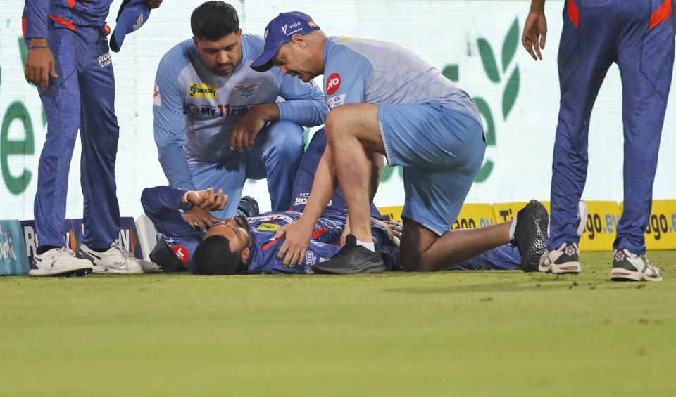 Medical staff examines Lucknow Super Giants' captain KL Rahul after he got injured while fielding during the Indian Premier League (IPL) match between Lucknow Super Giants and Royal Challenger Bangalore in Lucknow, India, Monday, May 1, 2023. (AP Photo/Surjeet Yadav)