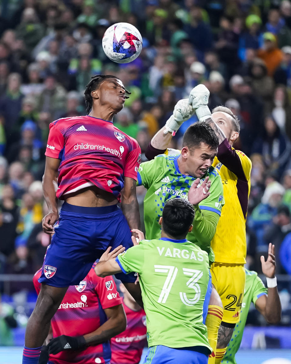 Seattle Sounders goalkeeper Stefan Frei (24) goes up against FC Dallas forward Dante Sealy, left, to punch out the ball as Sounders' Obed Vargas (73) and Jackson Ragen, facing, defend during the second half of Game 3 of a first-round MLS playoff soccer series Friday, Nov. 10, 2023, in Seattle. The Sounders won 1-0 to advance. (AP Photo/Lindsey Wasson)