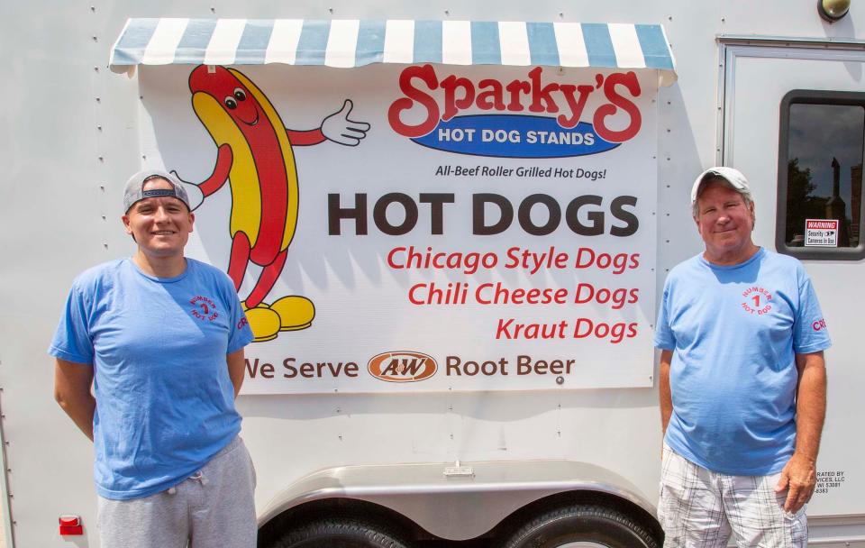 Kyle Hemsing, left, and Steven Hemsing stand outside their hotdog stand in the 800 block of South 8th St., Tuesday, July 12, 2022, in Sheboygan, Wis.