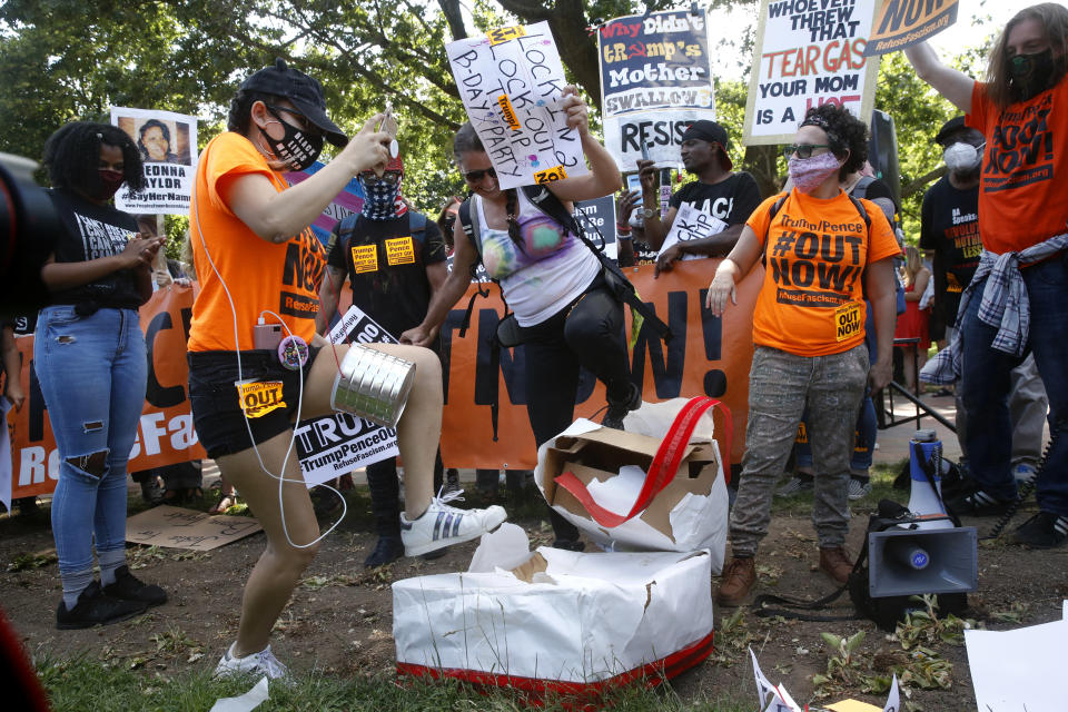 Protesters destroy a mock birthday cake for President Donald Trump on Trump's birthday, Sunday, June 14, 2020, in Lafayette Park near the White House in Washington. (AP Photo/Patrick Semansky)