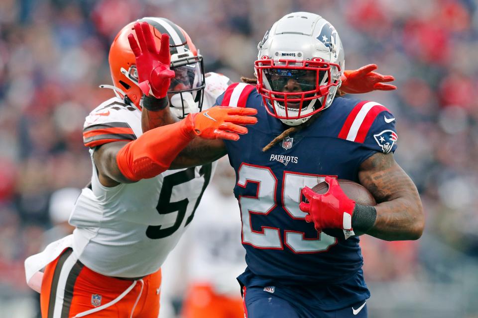 New England Patriots running back Brandon Bolden (25) tries to break free from Cleveland Browns outside linebacker Mack Wilson (51) during the second half of an NFL football game, Sunday, Nov. 14, 2021, in Foxborough, Mass. (AP Photo/Michael Dwyer)