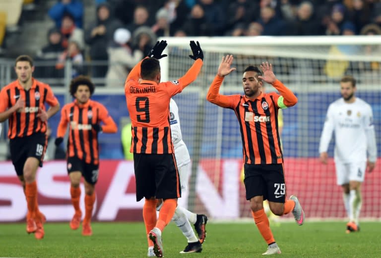 Shakhtar Donetsk's midfielder Alex Teixeira (R) celebrates with midfielder Dentinho after scoring during a UEFA Champions League match against Real Madrid in Lviv on November 25, 2015