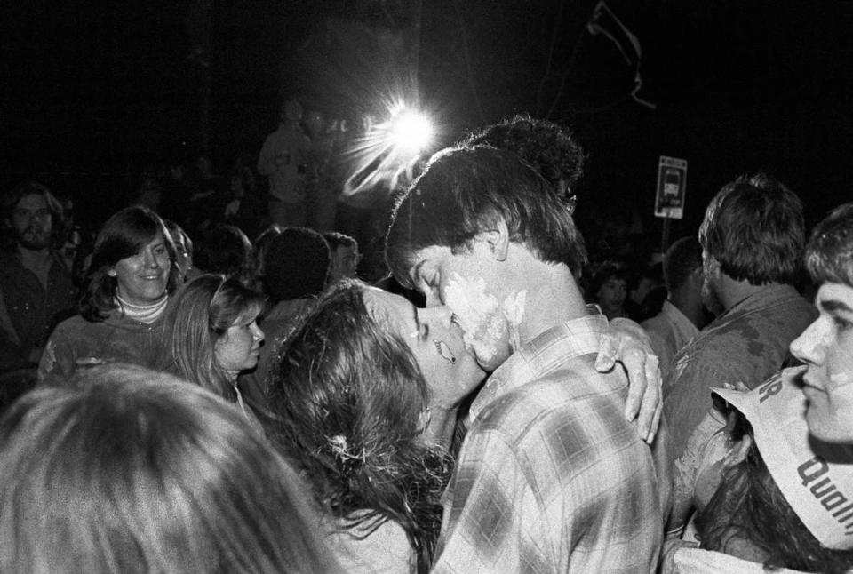 A couple kisses in the middle of hte celebration on Franklin Street in Chapel Hill, NC after the Tar Heels defeated Georgetown to win the 1982 National Championship.