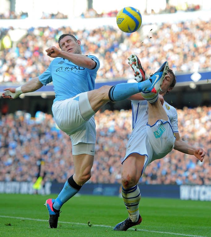 Leeds United's English defender Stephen Warnock (R) vies with Manchester City's English midfielder James Milner during the fifth round English FA Cup football match between Manchester City and Leeds United at the Etihad Stadium in Manchester on February 17, 2013. City won 4-0