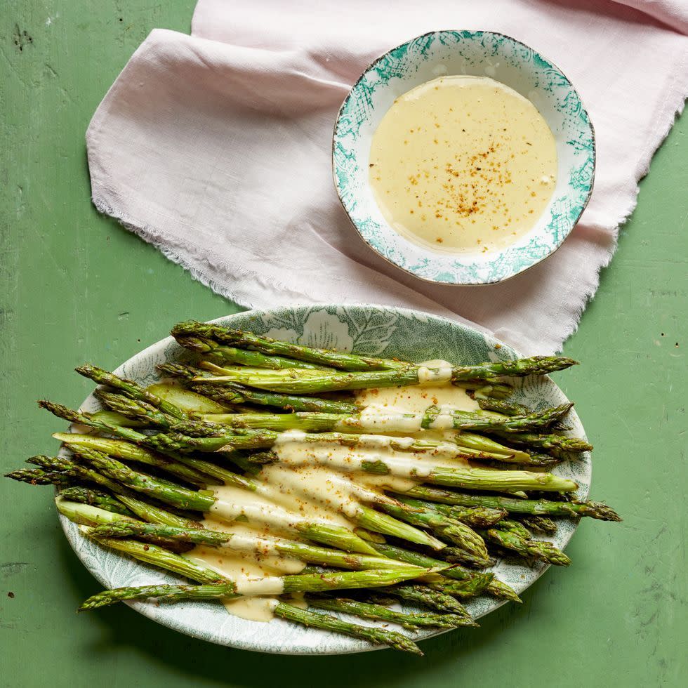 roasted asparagus with cajun hollandaise on green background