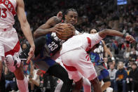 Brooklyn Nets center Nic Claxton (33) vies for the loose ball with Toronto Raptors' Kobi Simmons during the second half of an NBA basketball game in Toronto, Monday, March 25, 2024. (Nathan Denette/The Canadian Press via AP)
