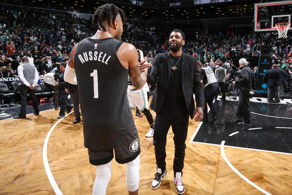 BROOKLYN, NY - MARCH 30: D'Angelo Russell #1 of the Brooklyn Nets and Kyrie Irving #11 of the Boston Celtics hug after the game on March 30, 2019 at Barclays Center in Brooklyn, New York. NOTE TO USER: User expressly acknowledges and agrees that, by downloading and or using this Photograph, user is consenting to the terms and conditions of the Getty Images License Agreement. Mandatory Copyright Notice: Copyright 2019 NBAE (Photo by Nathaniel S. Butler/NBAE via Getty Images)