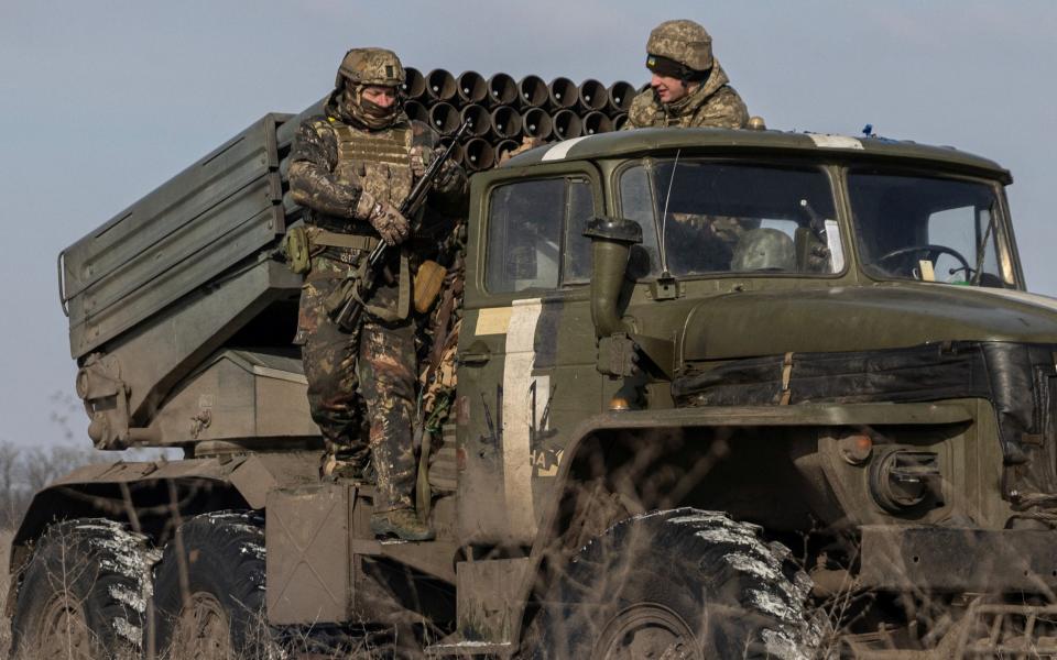 Ukrainian servicemen prepare to fire a BM-21 Grad - REUTERS/Marko Djurica