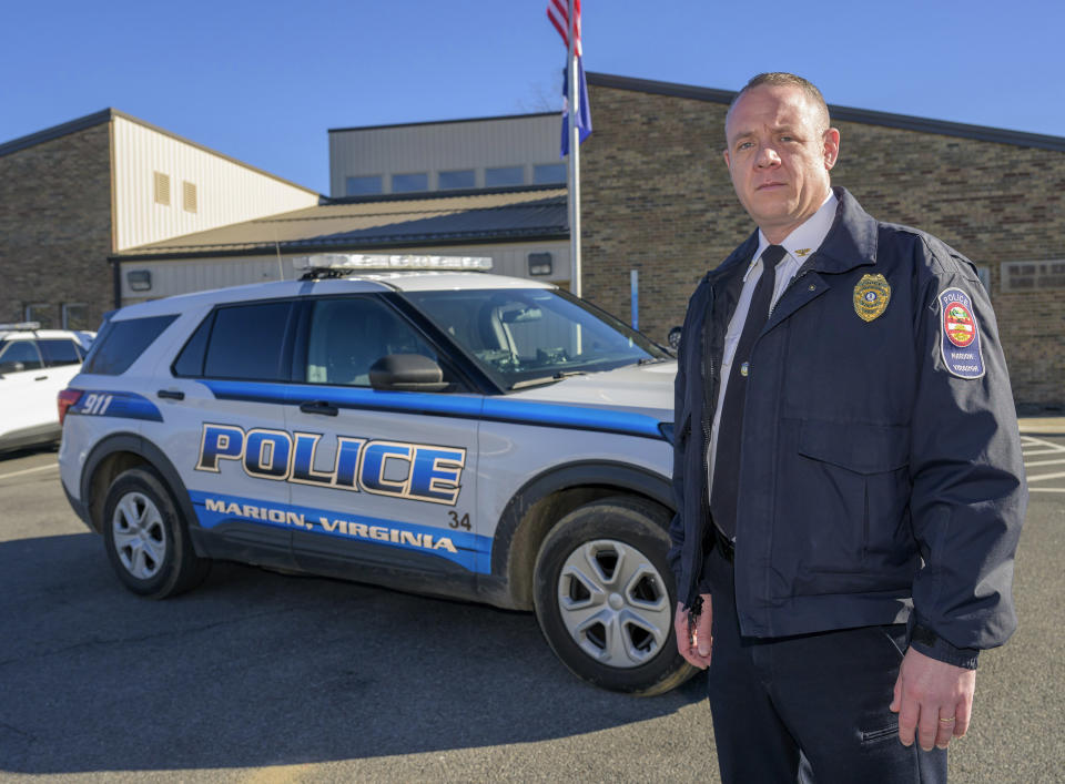 Marion Police Chief John Clair poses outside the Marion Police Department building, Monday, Feb. 5, 2024, in Marion, Va. Clair, chief of the small Appalachian town, spends his days consumed by a growing problem: the frequency with which his officers are tapped to detain, transport and wait in hospitals with people in the throes of a mental health crisis. (AP Photo/Earl Neikirk)