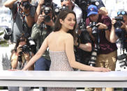 FILE - Marion Cotillard poses for photographers at the photo call for the film 'Brother and Sister' at the 75th international film festival, Cannes, southern France, Saturday, May 21, 2022. Star power has been out in force at the 75th Cannes Film Festival. After a 2021 edition muted by the pandemic, this year's French Riviera spectacular has again seen throngs of onlookers screaming out "Tom!" "Julia!" and "Viola!" The wattage on display on Cannes' red carpet has been brighter this year thanks the presence of stars like Tom Cruise, Julia Roberts, Viola Davis, Anne Hathaway, Idris Elba and others. But as the first half of the French Riviera spectacular has shown, stardom in Cannes is global. Just as much as cameras have focused on Hollywood stars, they've been trained on the likes of India's Aishwarya Rai and South Korea's Lee Jung-jae. (Photo by Vianney Le Caer/Invision/AP, File)