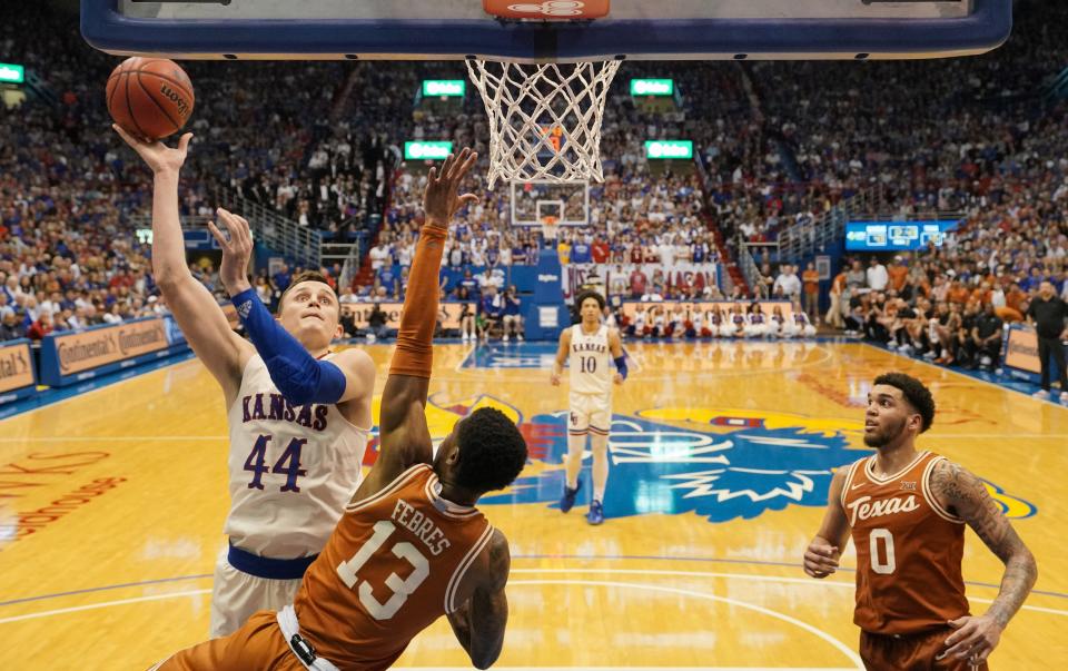 Kansas forward Mitch Lightfoot shoots as Texas guard Jase Febres defends during Saturday's game in Lawrence, Kan. The Longhorns will be the No. 4 seed in the Big 12 Tournament and will face No. 5 seed TCU on Thursday.