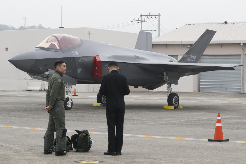 A South Korean fighter pilot, left, stands near F-35 A Stealth in the 71st anniversary of Armed Forces Day at the Air Force Base in Daegu, South Korea Tuesday, Oct. 1, 2019. (Jeon Heon-kyun/Pool Photo via AP)