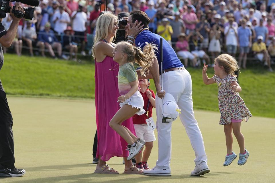 Billy Horschel celebrates with his family Sunday on the 18th green after winning the Memorial golf tournament in Dublin, Ohio. With him are wife Brittany, daughters Skylar and Colbie, and son Axel.