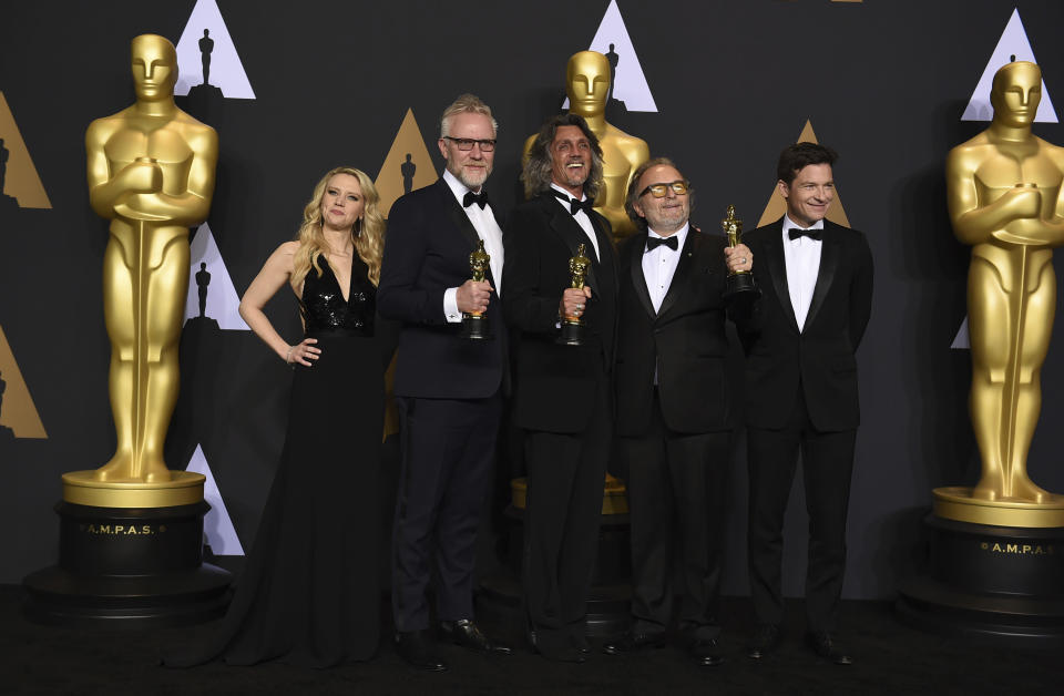 Christopher Nelson, second from left, Giorgio Giorgio, center, and Alessandro Bertolazzi, second from right, winners of the award for best makeup and hairstyling for "Suicide Squad" pose in the press room with Kate McKinnon, left, and Jason Bateman, right, in the press room at the Oscars on Sunday, Feb. 26, 2017, at the Dolby Theatre in Los Angeles. (Photo by Jordan Strauss/Invision/AP)