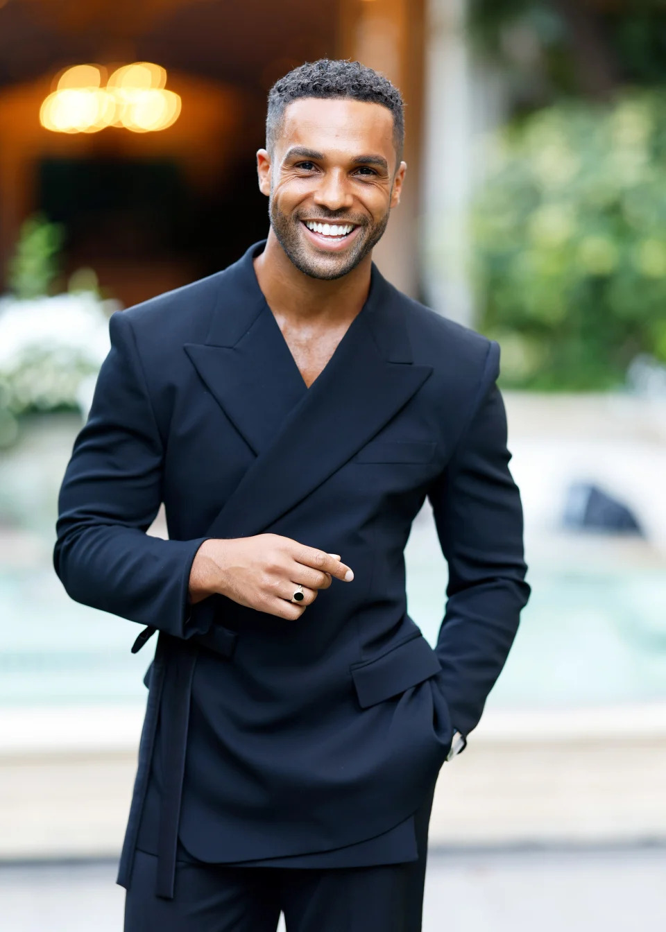 Lucien Laviscount in a sleek black suit