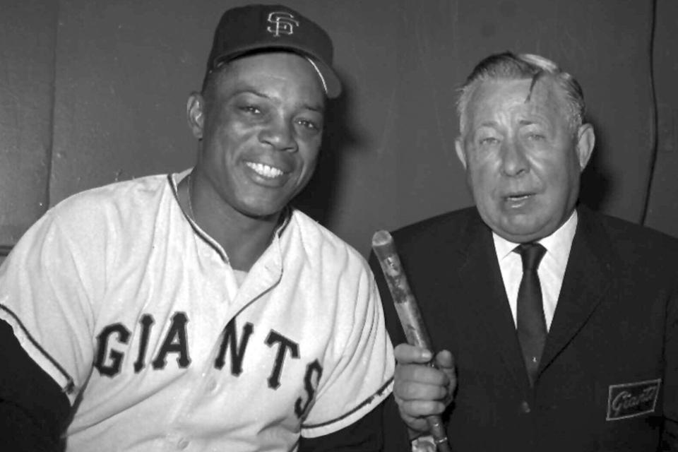 FILE - Russ Hodges, right, who has broadcast Giants games in New York and San Francisco for 18 years, interviews centerfielder Willie Mays on Aug. 30,1966 in San Francisco. Many baseball fans, especially older ones, originally fell in love with America’s pastime by listening to ballgames on AM radio. But several major automakers are eliminating broadcast AM radio from newer models, prompting lawmakers on Capitol Hill to propose legislation that would prevent the practice for safety and other reasons. (AP Photo/File)