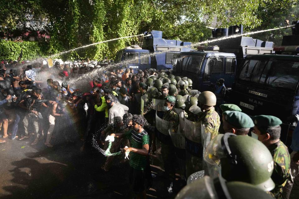 Police fire tear gas and water cannons to disperse protesting members of the Inter University Students Federation during an anti government protest in Colombo, Sri Lanka, Thursday, May 19, 2022. Sri Lankans have been protesting for more than a month demanding the resignation of President Gotabaya Rajapaksa, holding him responsible for the country's worst economic crisis in recent memory. (AP Photo/Eranga Jayawardena)