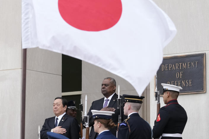 Defense Secretary Lloyd Austin and Japanese Defense Minister Yasukazu Hamada, left, listen to their national anthems during a welcome ceremony at the Pentagon in Washington, Thursday, Jan. 12, 2023. (AP Photo/Susan Walsh)