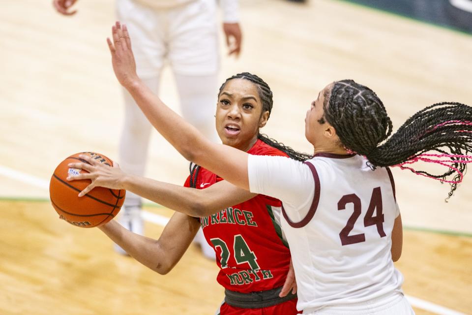 Lawrence North High School senior Ellysa Morris (24) shoots while being defended by Lawrence Central High School sophomore Aniyah Mckenzie (24) during the second half of an IHSAA Class 4A Sectional semi-final basketball game, Friday, Feb. 2, 2024, at Cathedral High School. Lawrence Central won, 61-54.