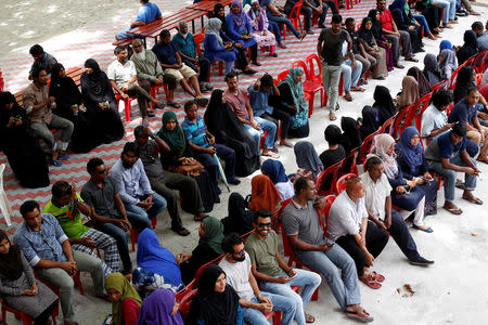 Peolple sit in line as they wait to cast their votes at a polling station during the presidential election in Male, Maldives September 23, 2018. REUTERS/Ashwa Faheem