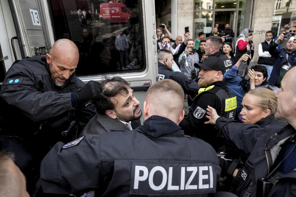 Police officers detain people who take part in a pro-Palestinians protest rally in Berlin, Saturday, April 27, 2024. (AP Photo/Ebrahim Noroozi)