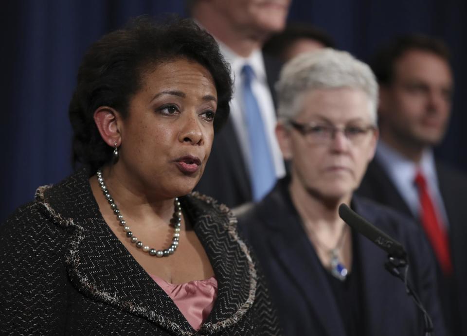 Attorney General Loretta Lynch, accompanied by Environmental Protection Agency Administrator Gina McCarthy, right, and others, speaks during a news conference at the Justice Department in Washington, Wednesday, Jan. 11, 2017, to discuss Volkswagen emissions. Six high-level Volkswagen employees have been indicted by a grand jury in the company's diesel emissions cheating scandal, as the company admitted wrongdoing and agreed to pay a record $4.3 billion penalty. (AP Photo/Manuel Balce Ceneta)