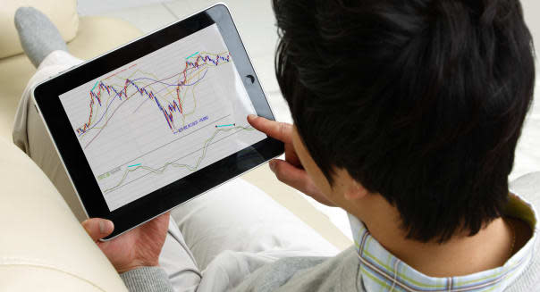 Man looking stock market on digital tablet