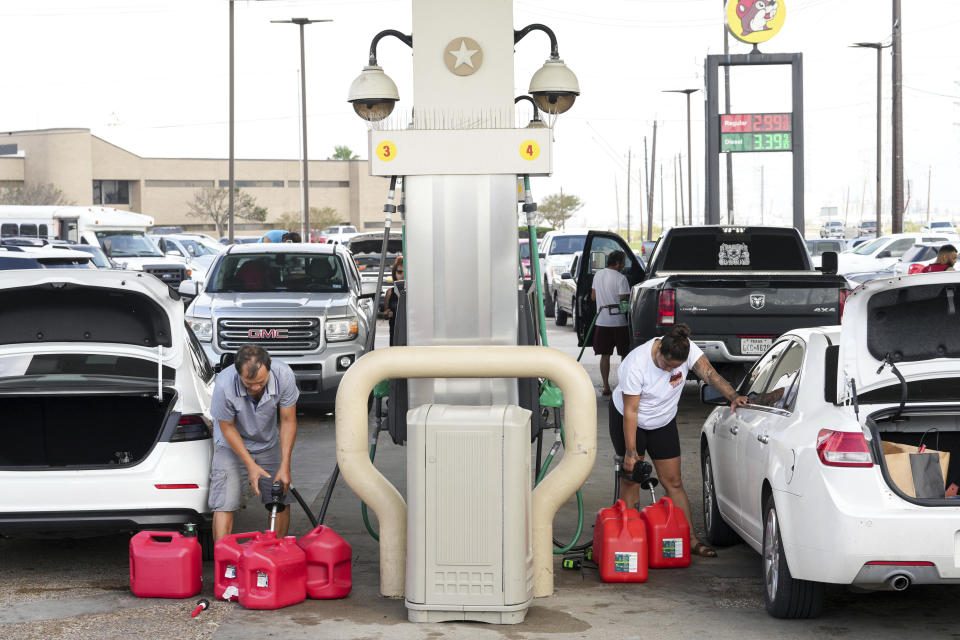People fill gas cans the day after Hurricane Beryl made landfall nearby Tuesday, July 9, 2024, in Freeport, Texas. (Jon Shapley/Houston Chronicle via AP)