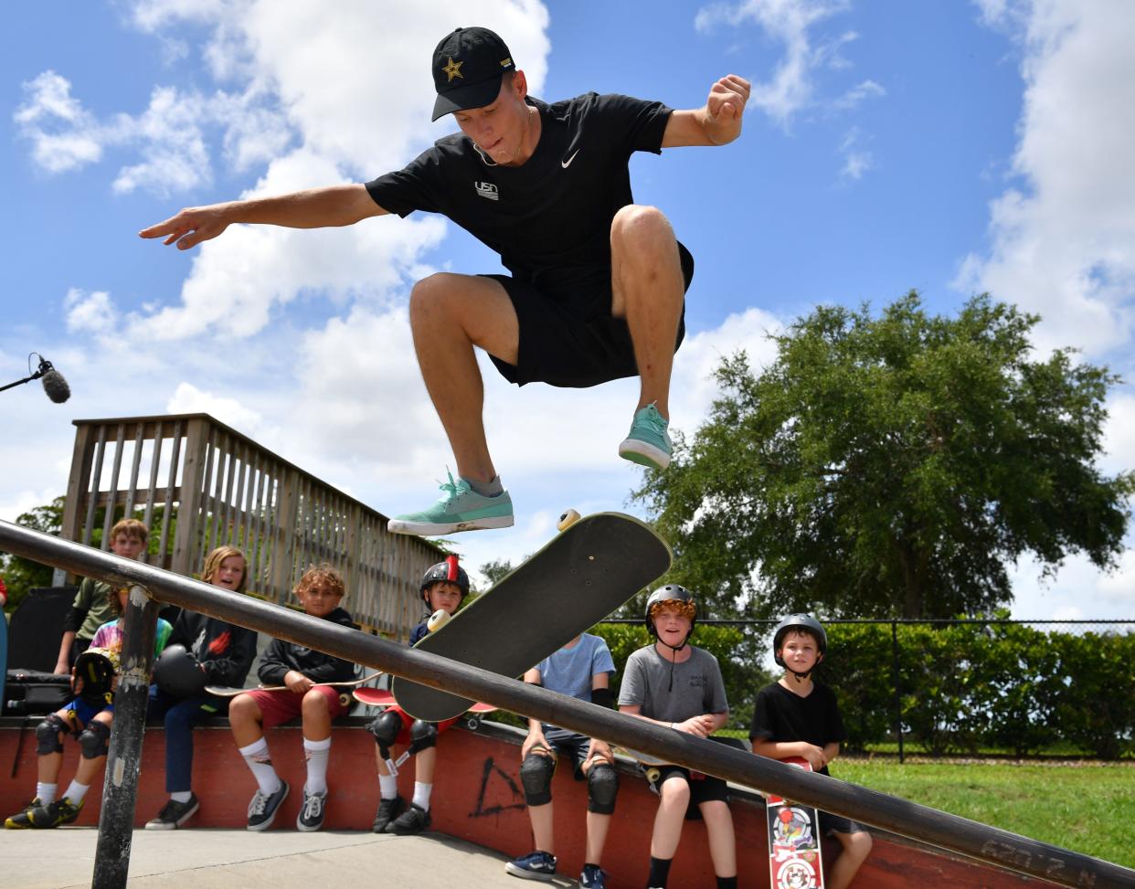 U.S. Olympic skateboard team member Jake Ilardi performs a trick on one of the new rails installed at Payne Skate Park in 2021 as kids in a Compound Board Shop summer camp watch. Ilardi raised funds to build a new quarter-pipe and install a few new rails at the city of Sarasota's then-18-year old skate park.