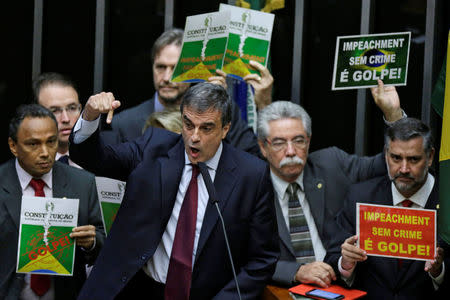 Brazil's General Attorney Jose Eduardo Cardozo speaks during a session to review the request for Brazilian President Dilma Rousseff's impeachment at the Chamber of Deputies in Brasilia, Brazil April 15, 2016. The banners read "Impeachment without a crime is a coup." REUTERS/Ueslei Marcelino