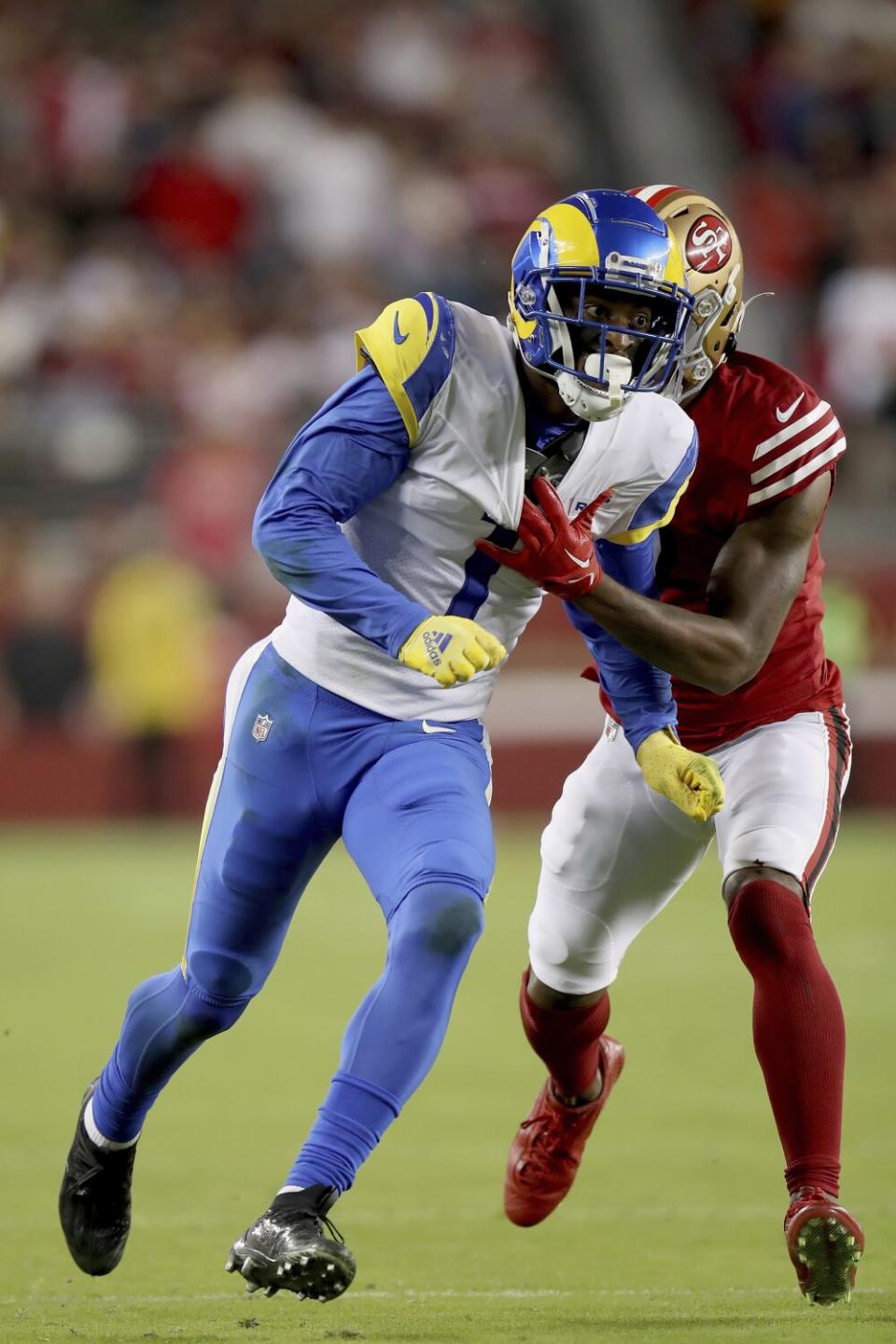 Rams receiver Allen Robinson II fights off 49ers cornerback Charvarius Ward while running a pass route.