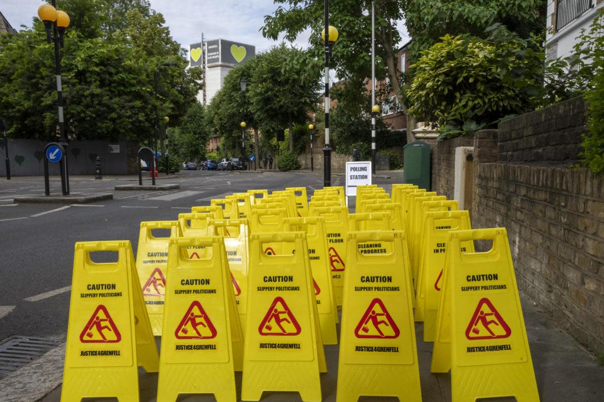 Signs outside the polling station near Grenfell Tower read "Caution, Slippery Politicians" <i>(Image: Jeff Moore)</i>